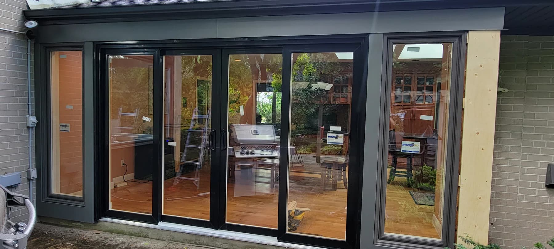 Multi-panel aluminum folding door installed by Better View, opening onto a deck