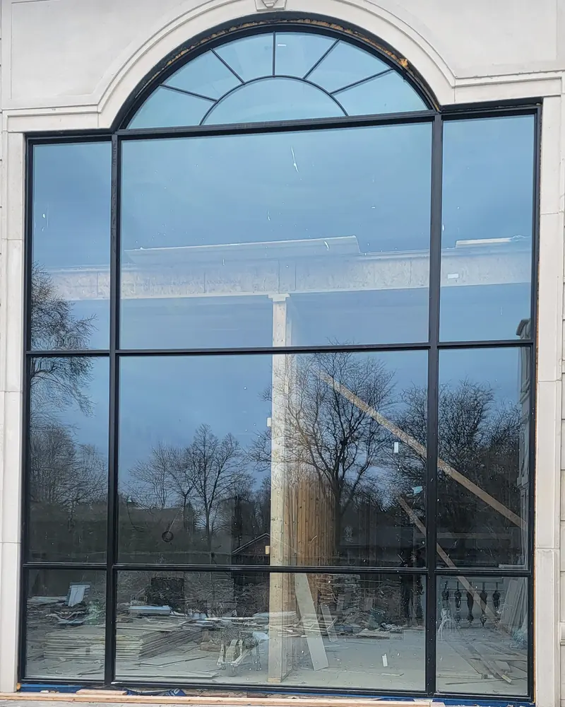 Two-storey arched glass wall