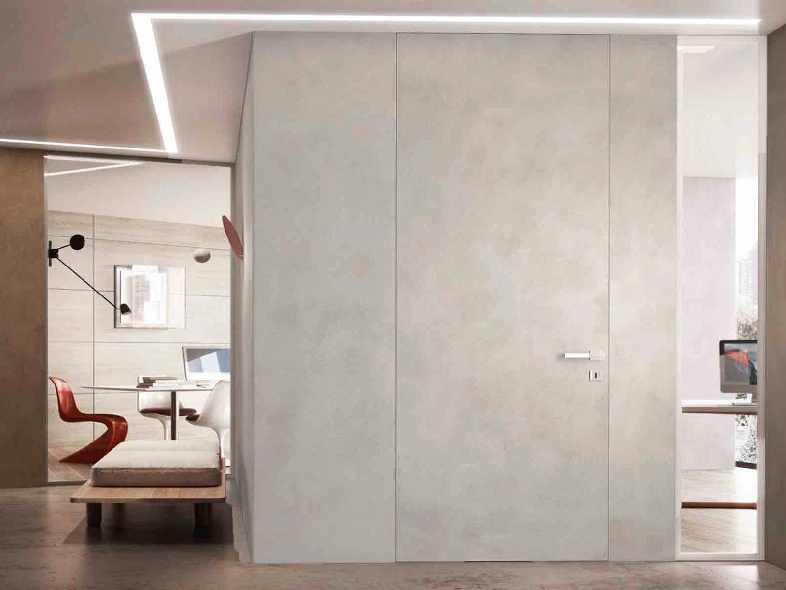 Cement finish frameless interior door flush with the wall