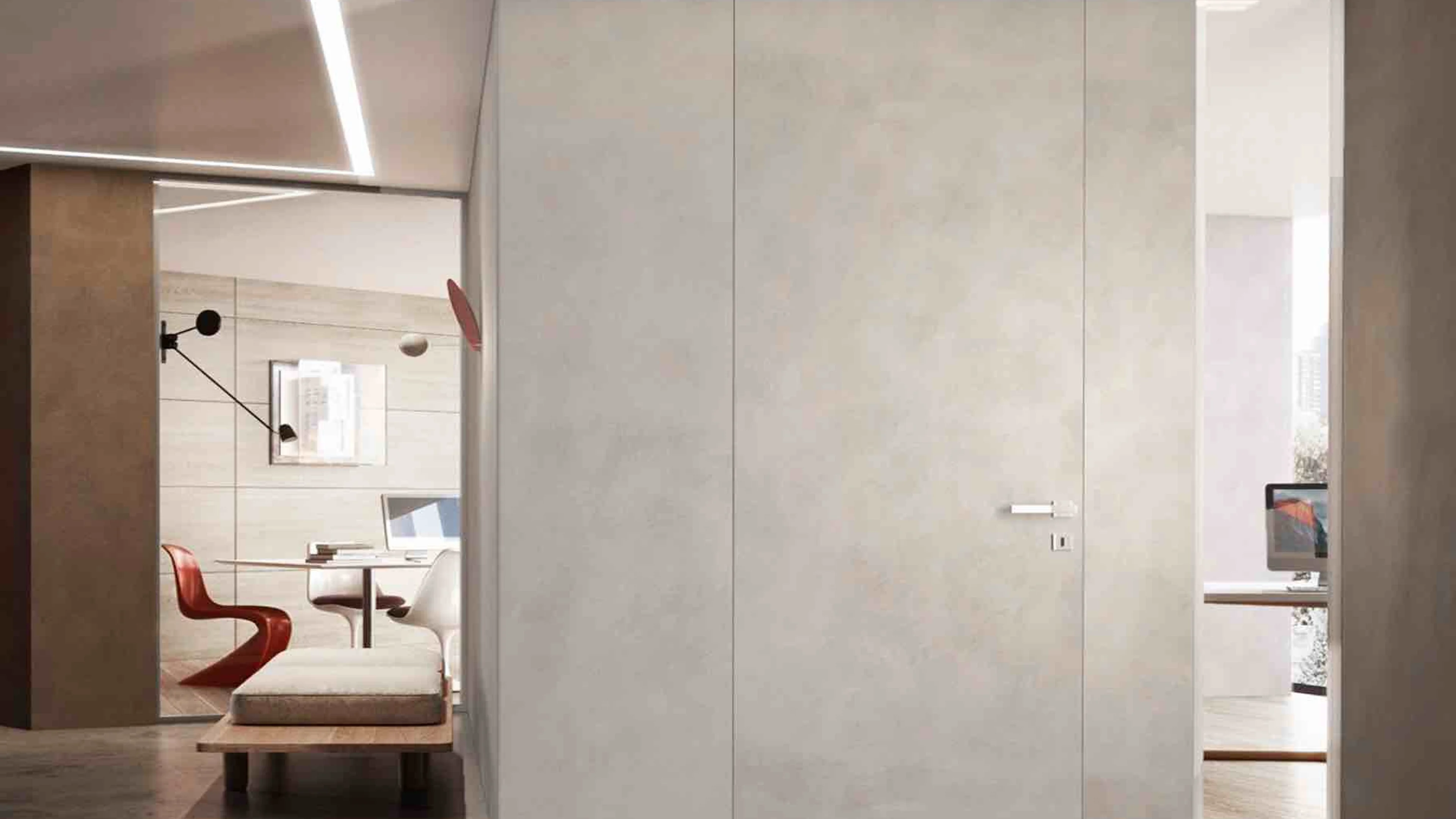 Cement finish frameless interior door flush with the surrounding wall