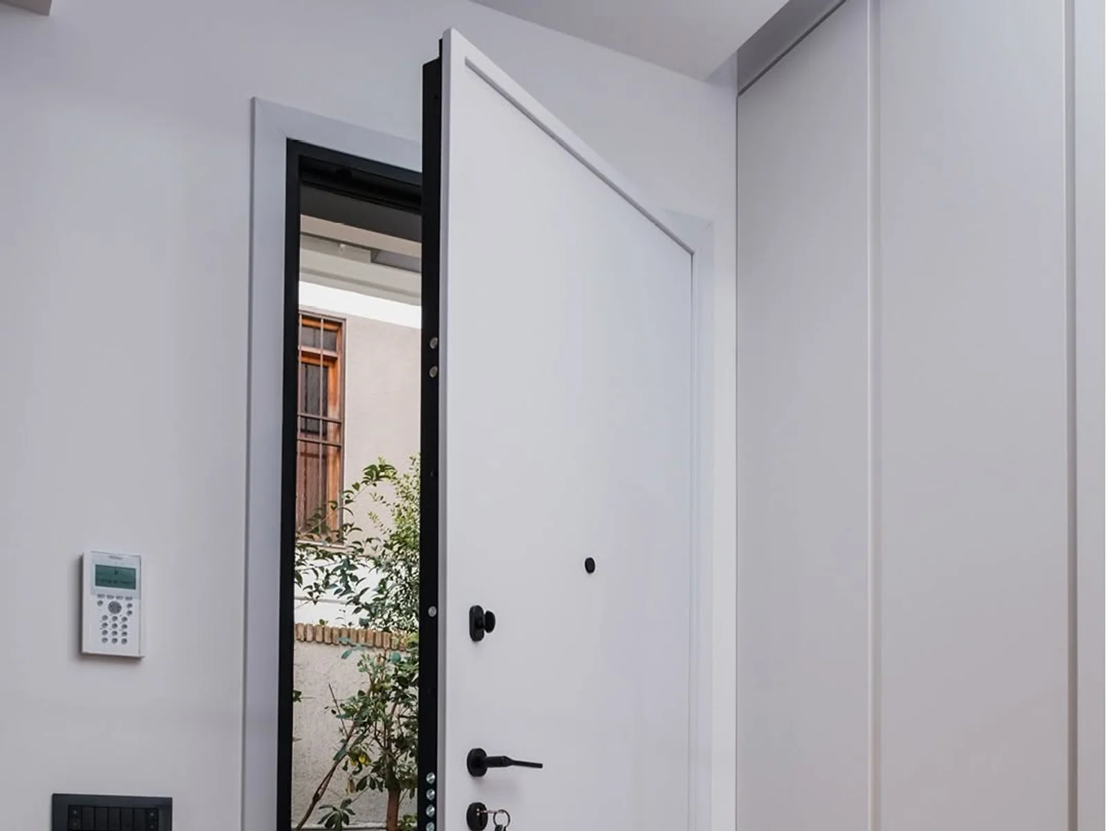 White security door opened into a bright interior entry